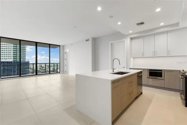 a view of a kitchen with a sink and cabinets