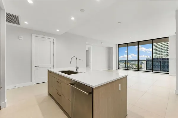 a kitchen with a sink and large window