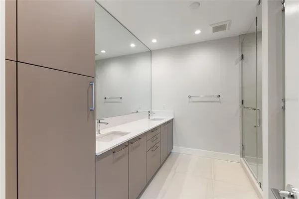 a bathroom with a double vanity sink and mirror