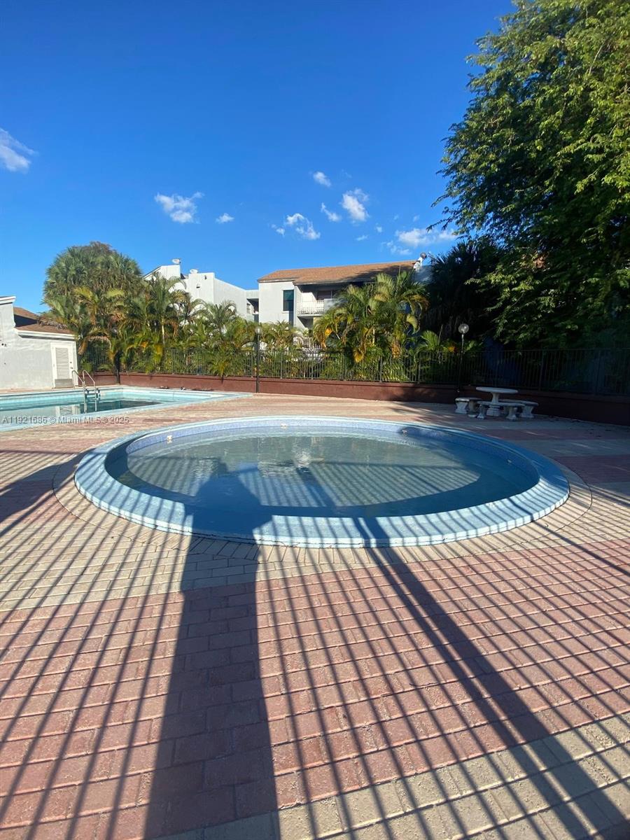 1725 West 60th Street, Unit F128 Hialeah, FL 33012 - Photo 18 of 21 a view of yard from deck with outdoor seating