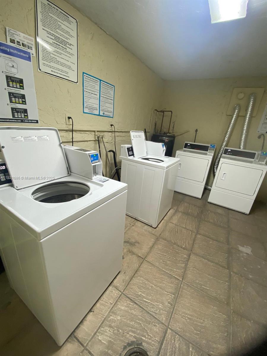 1725 West 60th Street, Unit F128 Hialeah, FL 33012 - Photo 21 of 21 a room with a washing machine and a sink