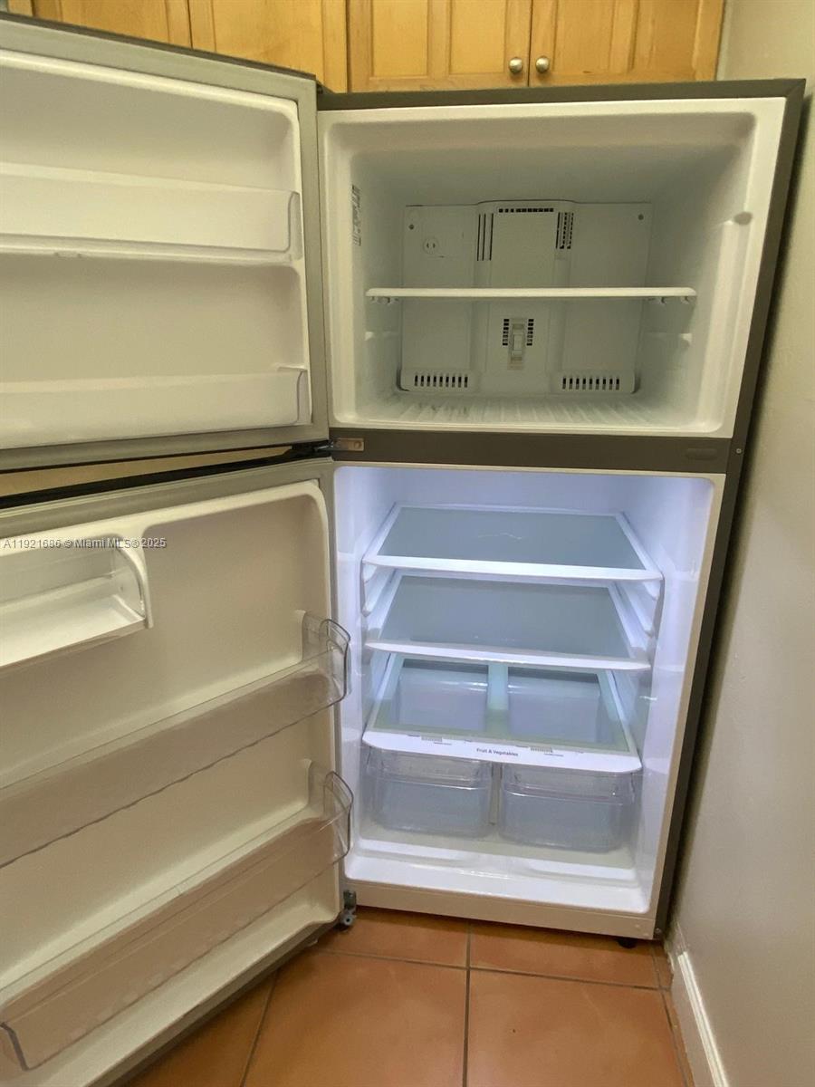 1725 West 60th Street, Unit F128 Hialeah, FL 33012 - Photo 7 of 21 a view of walk in closet with empty racks