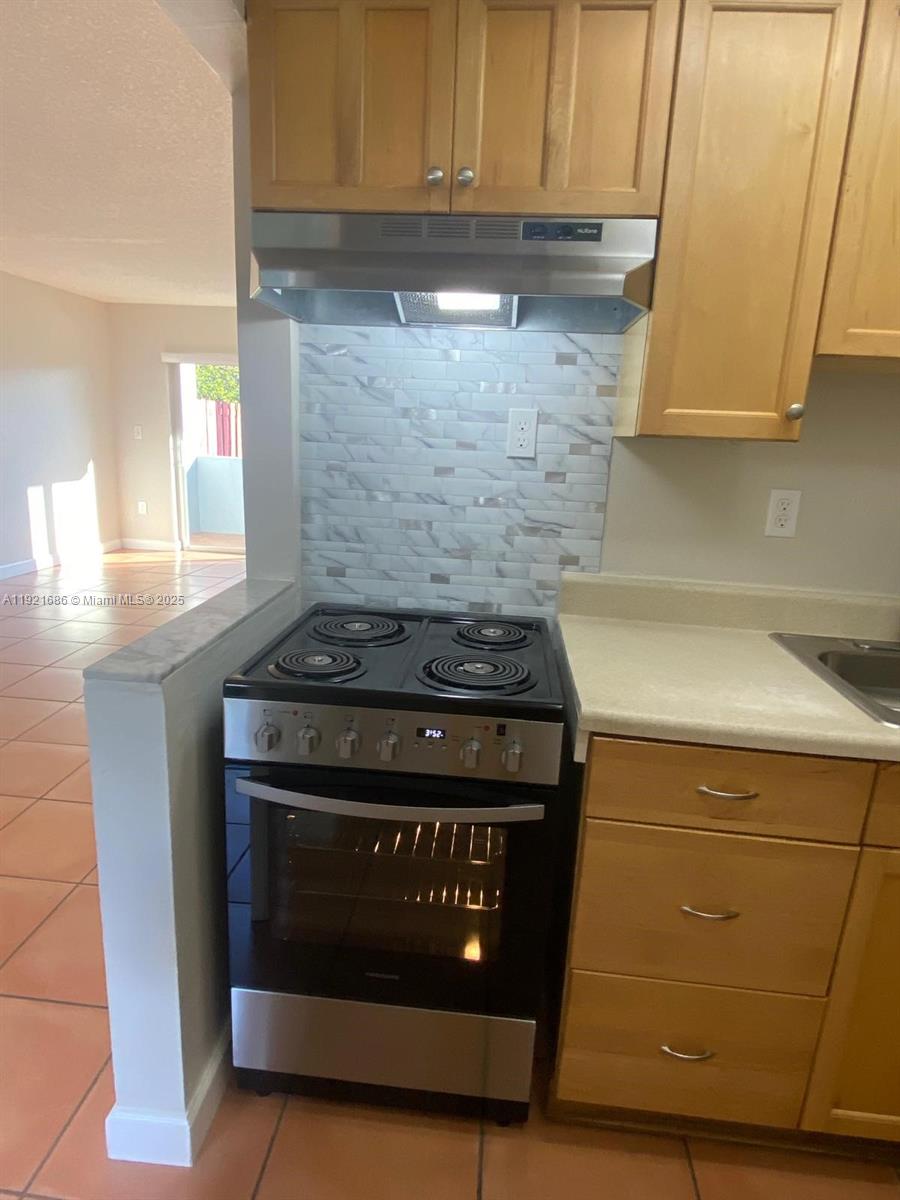 1725 West 60th Street, Unit F128 Hialeah, FL 33012 - Photo 8 of 21 a stove top oven sitting inside of a kitchen