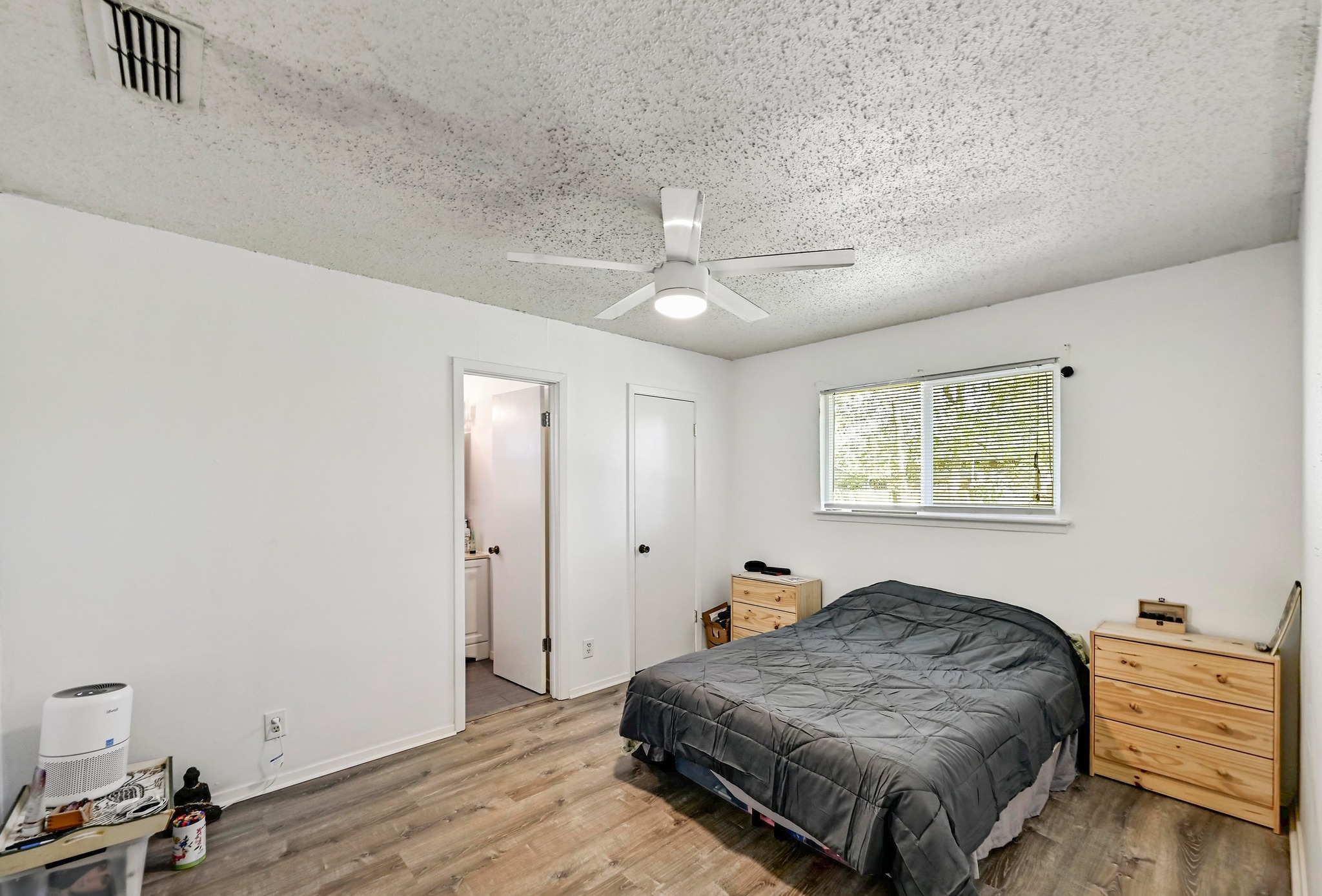 1208 Milford Way Austin, TX 78745 - Photo 12 of 22 a spacious bedroom with a bed and a chandelier
