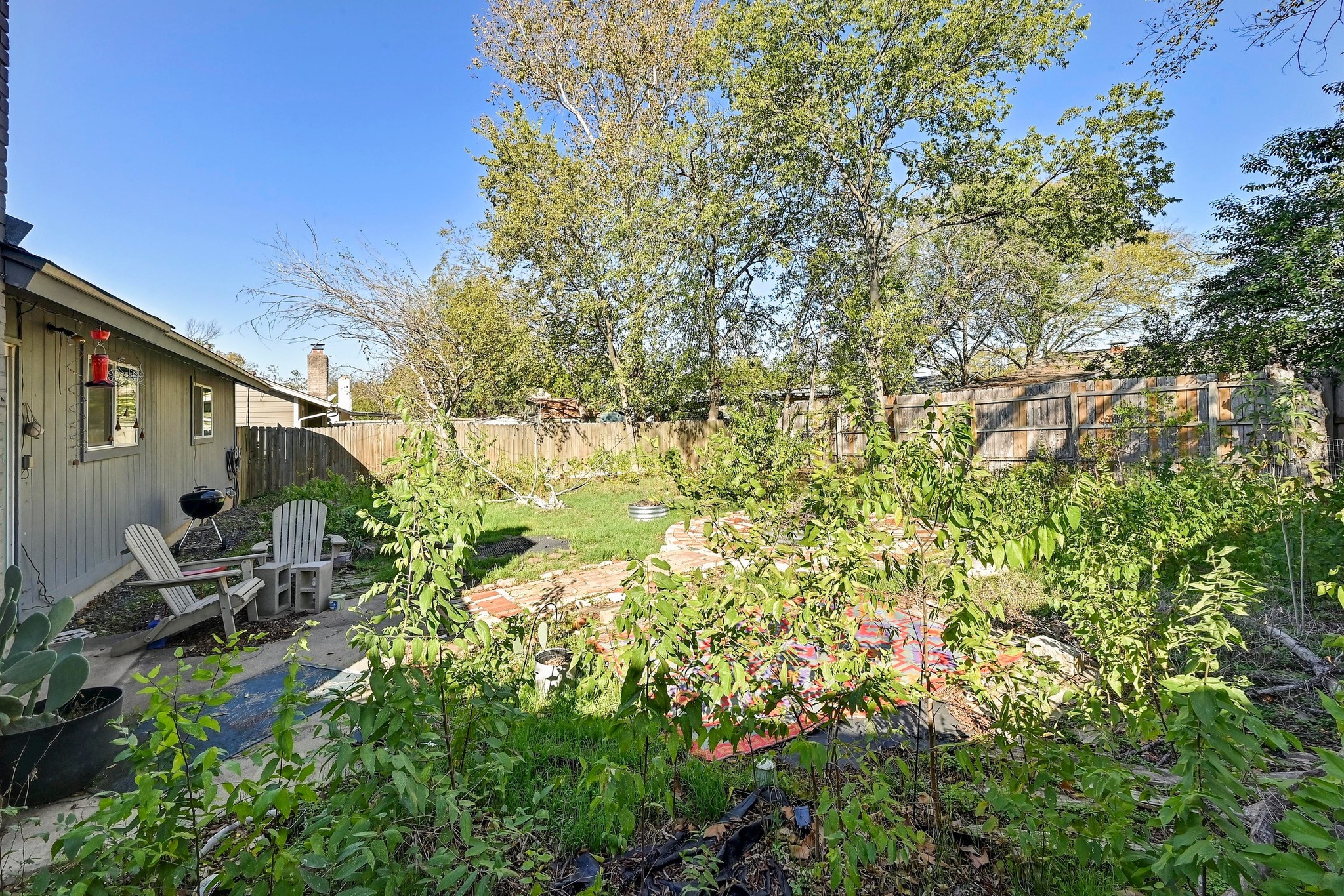 1208 Milford Way Austin, TX 78745 - Photo 17 of 22 a backyard of a house with table and chairs