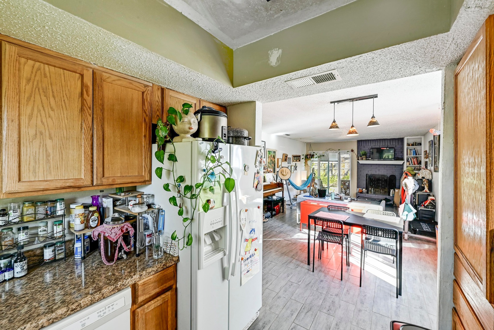 1208 Milford Way Austin, TX 78745 - Photo 10 of 22 a kitchen with stainless steel appliances granite countertop a refrigerator and table chairs