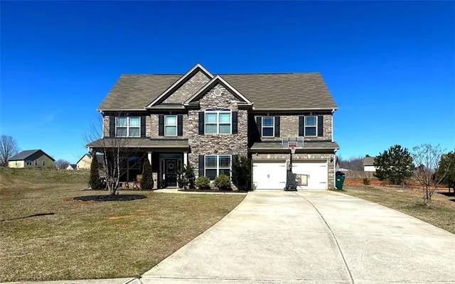 a view of a brick house with large windows