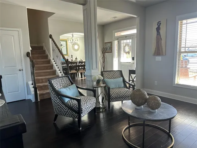 a living room with furniture and a potted plant