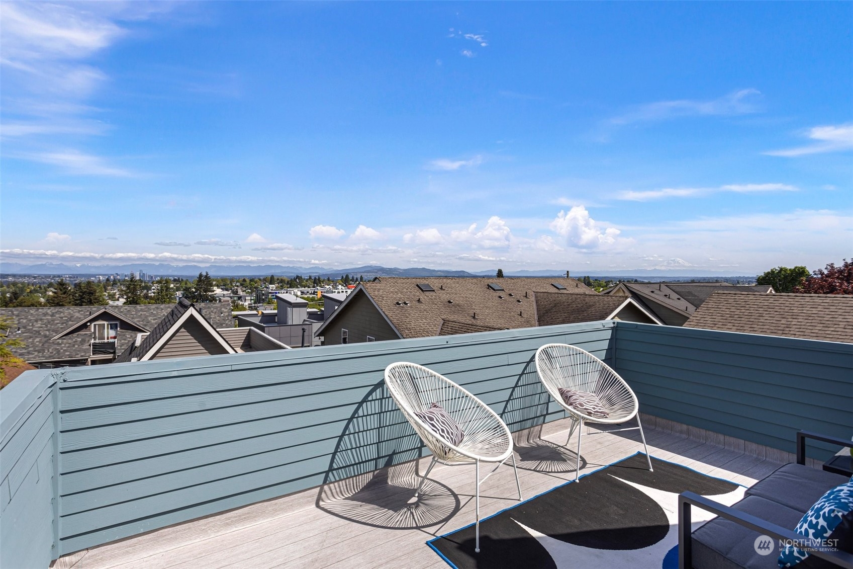 1424 18th Avenue Seattle, WA 98122 - Photo 22 of 29 a view of a patio with table and chairs with wooden floor and fence