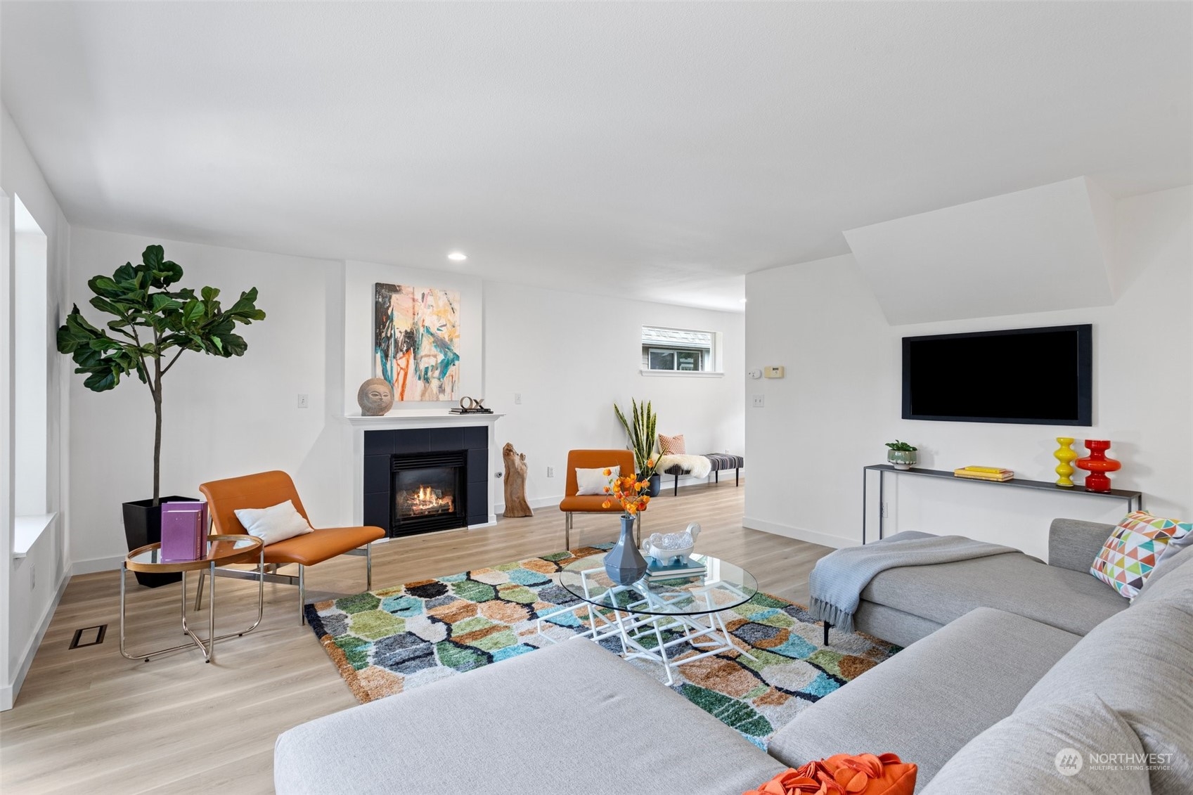 1424 18th Avenue Seattle, WA 98122 - Photo 4 of 29 a living room with furniture a fireplace and a flat screen tv