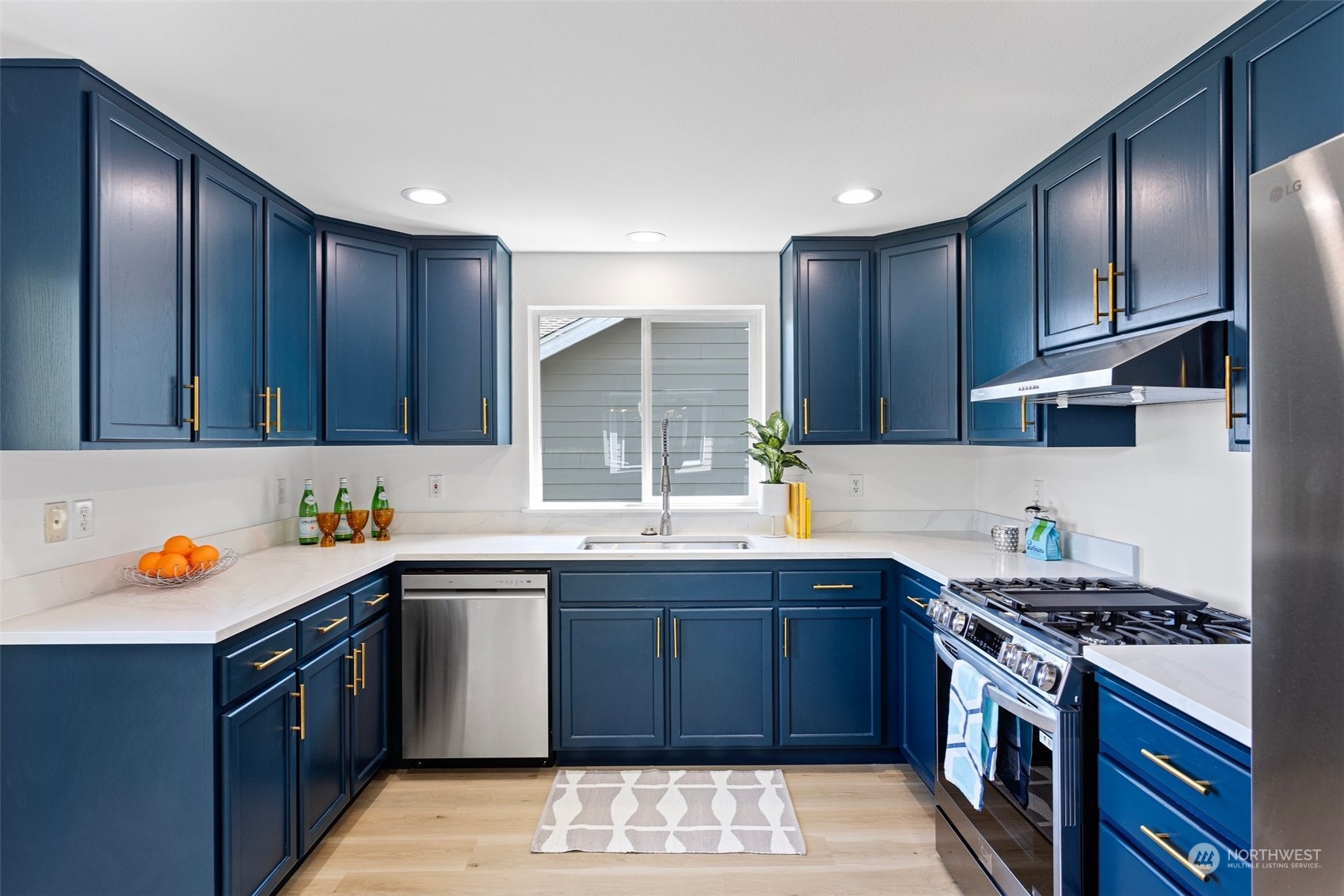 1424 18th Avenue Seattle, WA 98122 - Photo 6 of 29 a kitchen with stainless steel appliances granite countertop wooden cabinets a sink and a stove