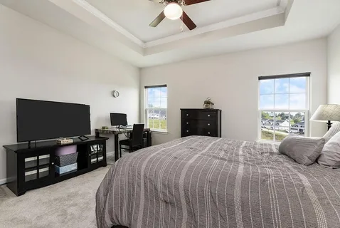 a bedroom with a bed and a flat screen tv