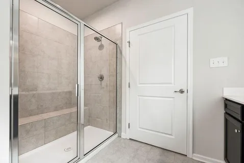 a bathroom with a glass shower door