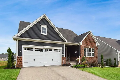 a view of a house with backyard and garden