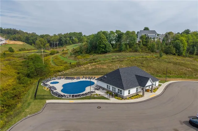 a view of a swimming pool with a yard