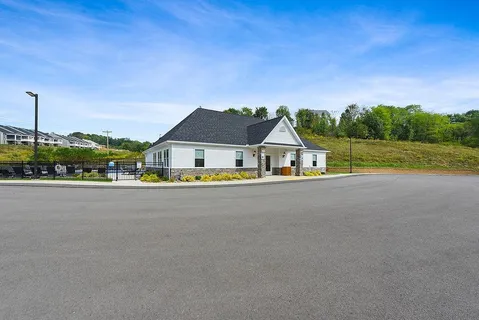a group of people sitting at kitchen counter space with furniture and windows