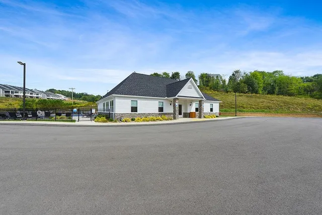 a group of people sitting at kitchen counter space with furniture and windows