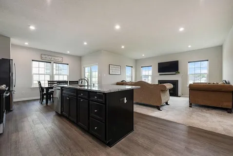 a living room with couches and furniture with wooden floor