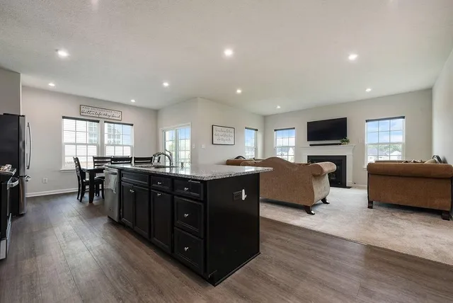 a living room with couches and furniture with wooden floor