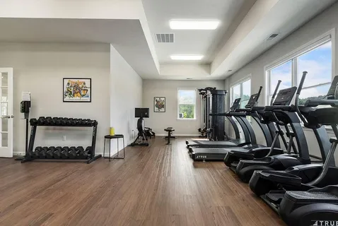 a view of kitchen with stainless steel appliances granite countertop a sink a stove and a refrigerator