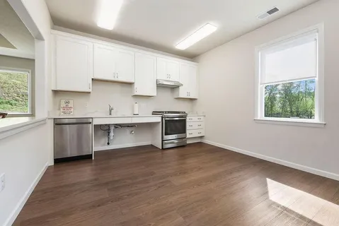 a view of a dining room with furniture and a book shelf