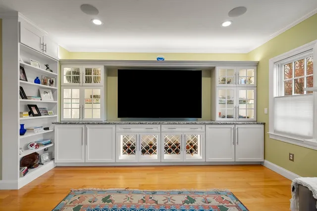 a living room with stainless steel appliances kitchen island granite countertop furniture and a fireplace