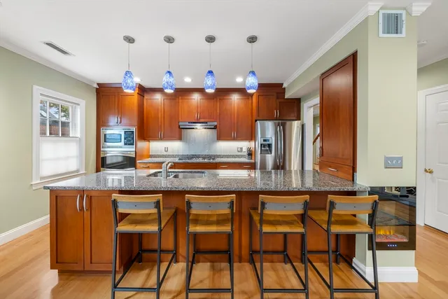 a kitchen with granite countertop a sink stove and cabinets