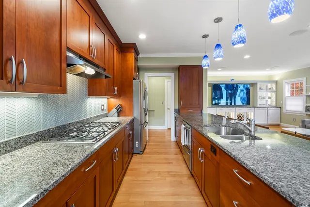 a large kitchen with kitchen island a sink table and chairs