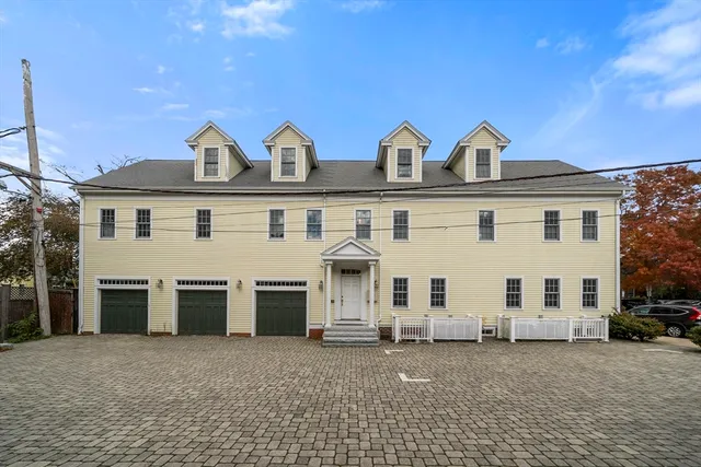 a view of a house with a yard and garage
