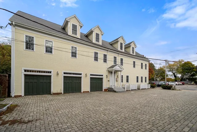 a view of a white house with large windows