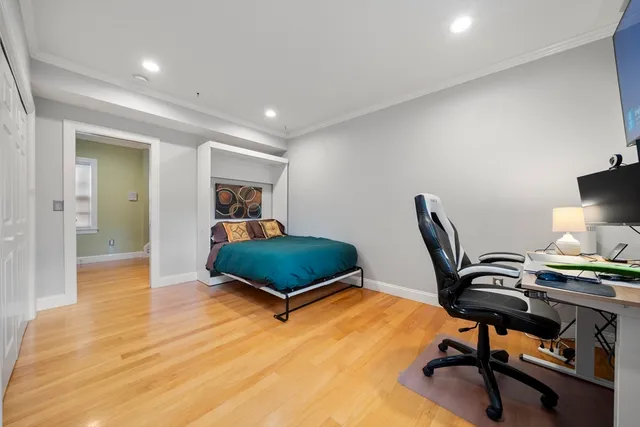 a bedroom with furniture and a wooden floor