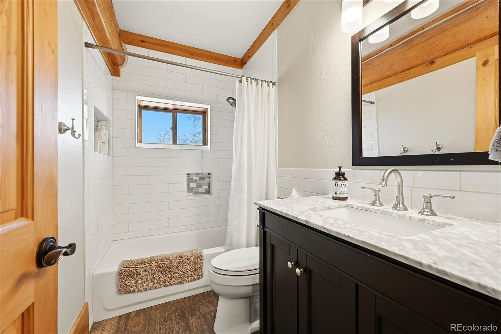 252 Iron Mountain Road Fairplay, CO 80440 - Photo 13 of 50 a bathroom with a granite countertop sink toilet and shower