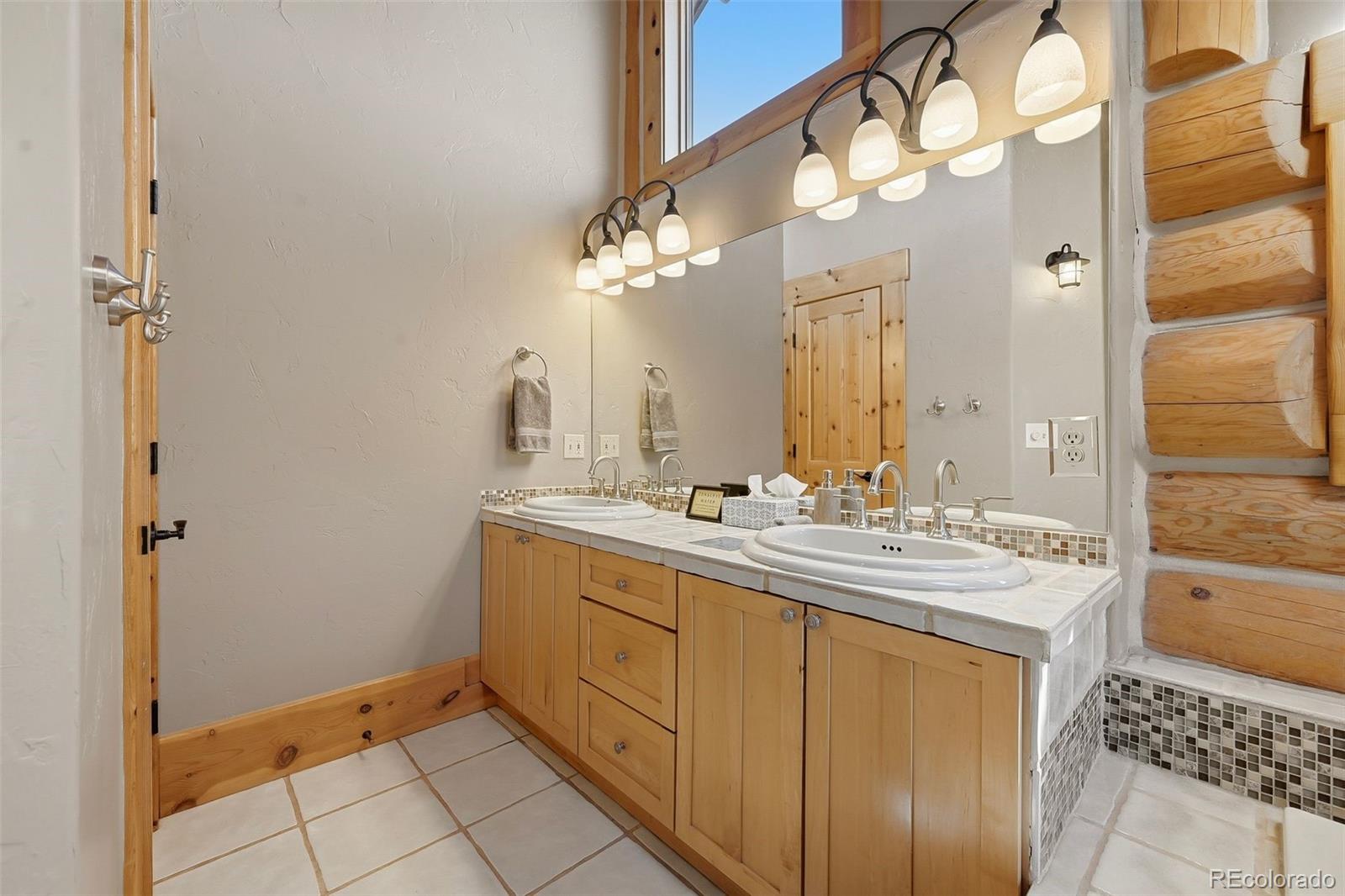 252 Iron Mountain Road Fairplay, CO 80440 - Photo 18 of 50 a bathroom with a sink a mirror and a shower