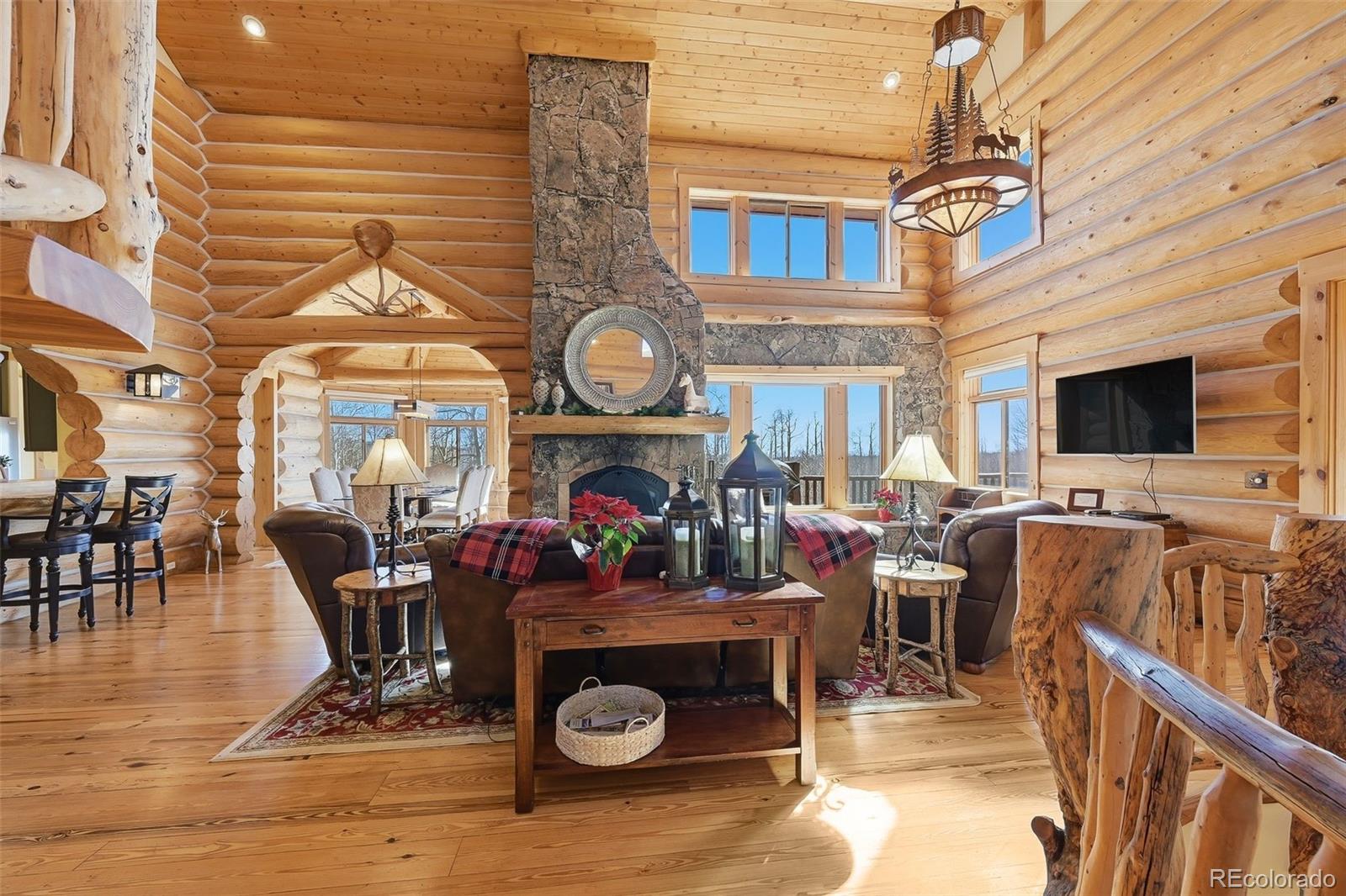252 Iron Mountain Road Fairplay, CO 80440 - Photo 2 of 50 a living room with furniture a flat screen tv and a fireplace