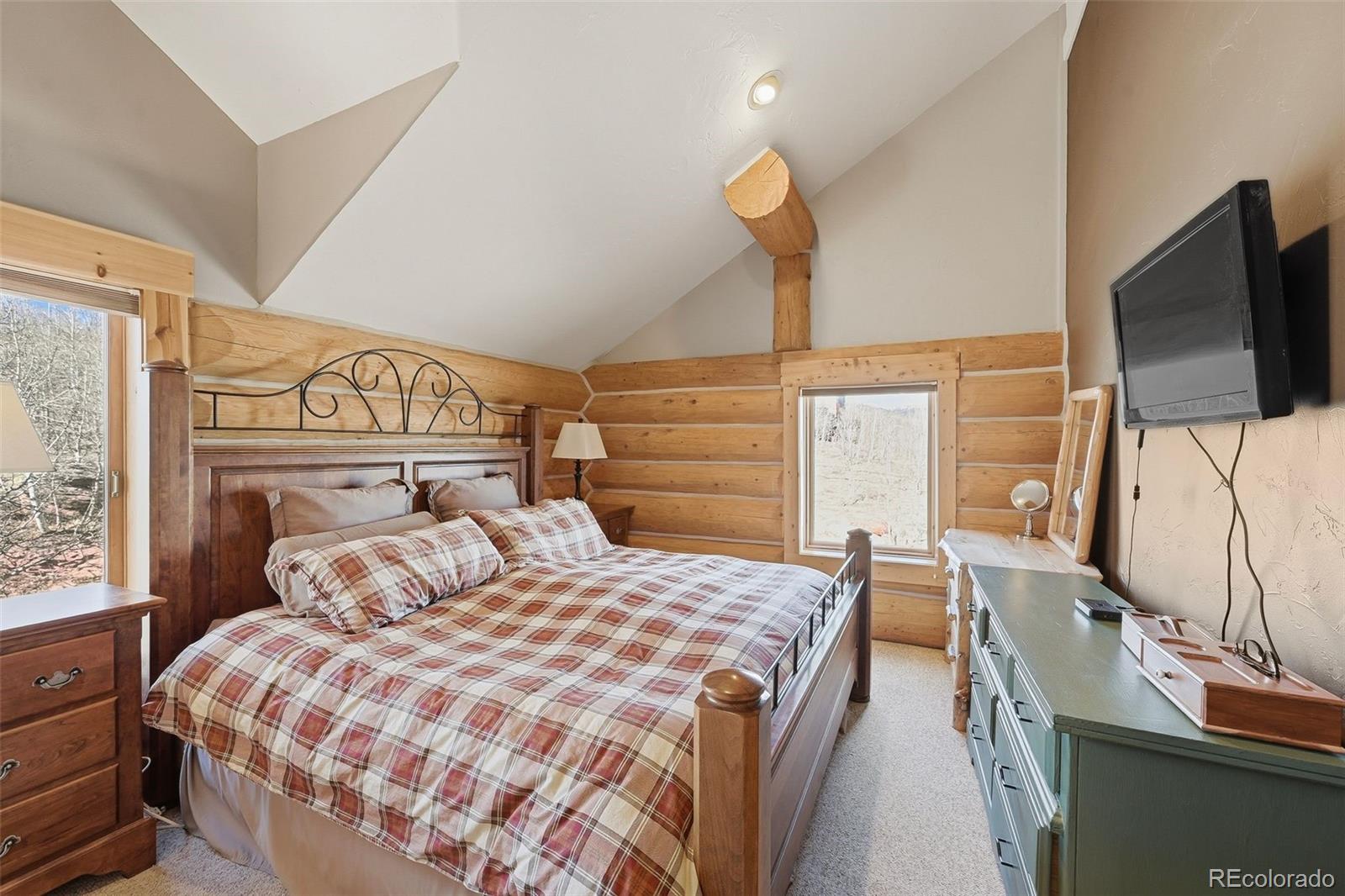 252 Iron Mountain Road Fairplay, CO 80440 - Photo 31 of 50 a bedroom with a bed and flat screen tv