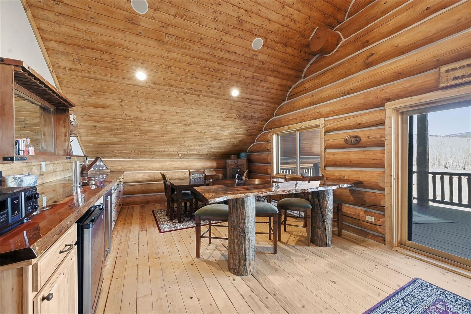 252 Iron Mountain Road Fairplay, CO 80440 - Photo 45 of 50 a view of a patio with table and chairs a barbeque with wooden floor and fence