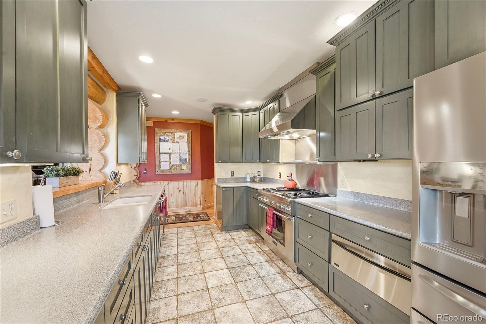 252 Iron Mountain Road Fairplay, CO 80440 - Photo 7 of 50 a kitchen with stainless steel appliances granite countertop a sink stove and cabinets