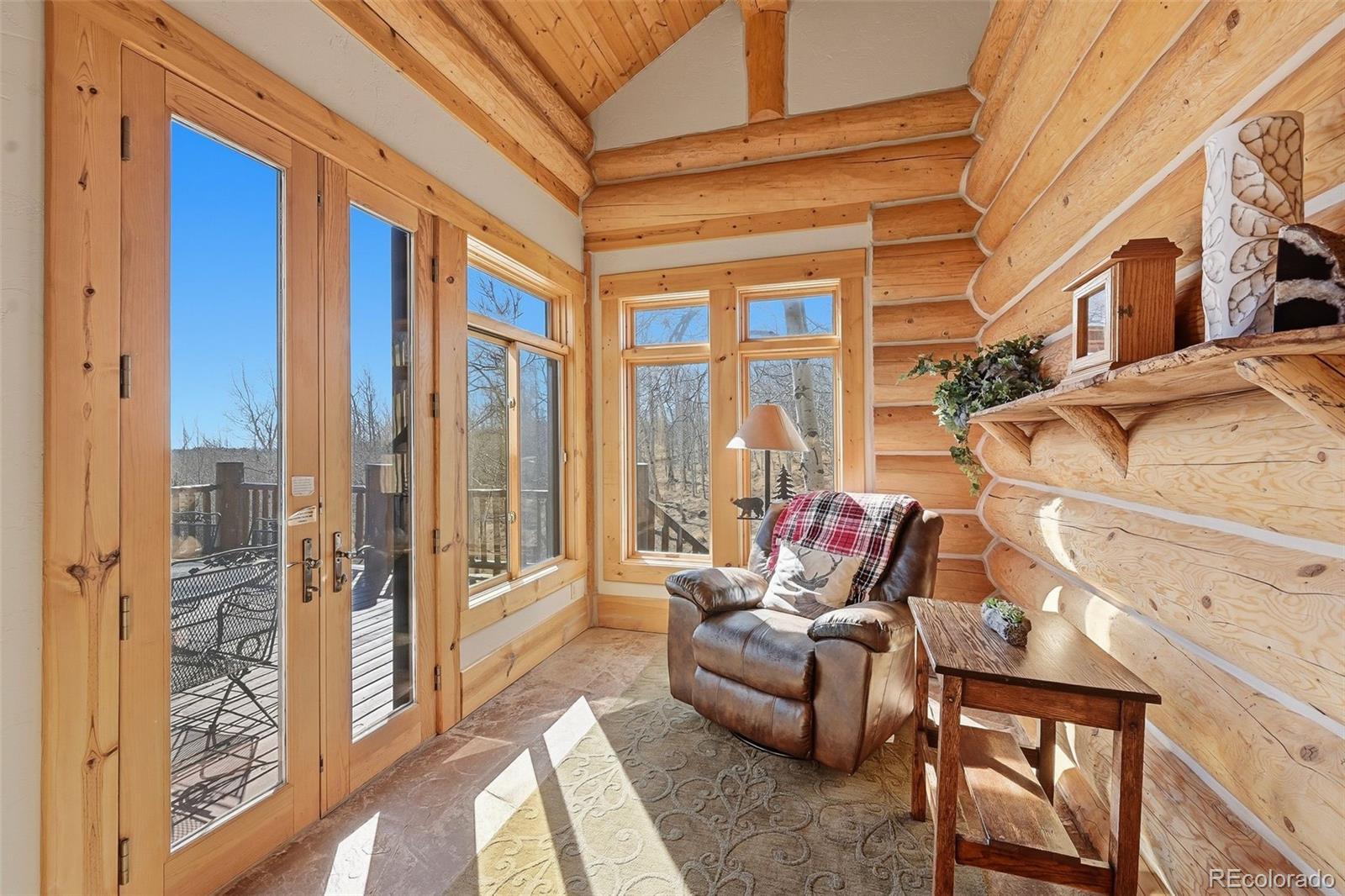 252 Iron Mountain Road Fairplay, CO 80440 - Photo 9 of 50 a living room with furniture and a floor to ceiling window