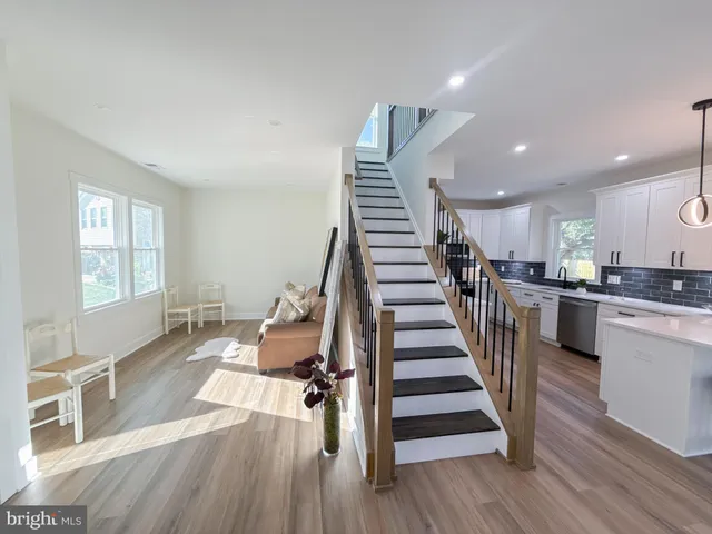 a view of a living room and dining room with wooden floor