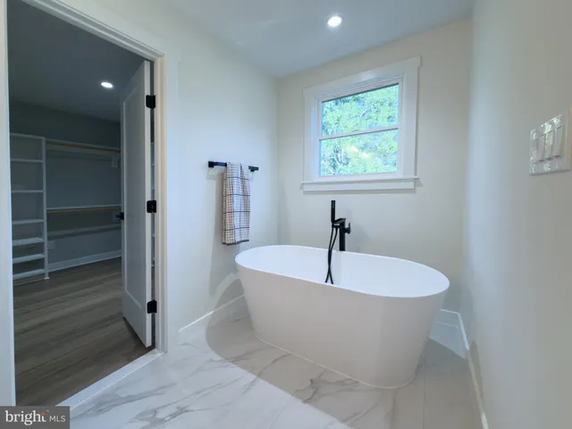 a white bath tub sitting in a bathroom