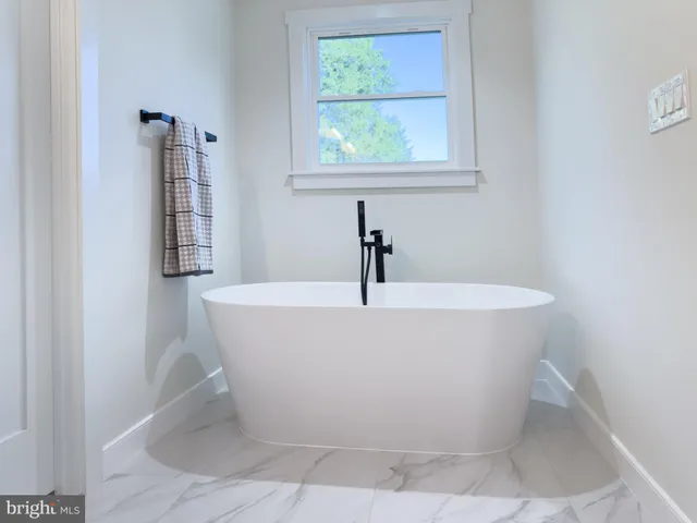 a white bath tub sitting in a bathroom