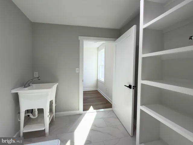 a spacious bedroom with a bed and a chair