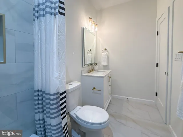 a bathroom with a toilet sink and shower