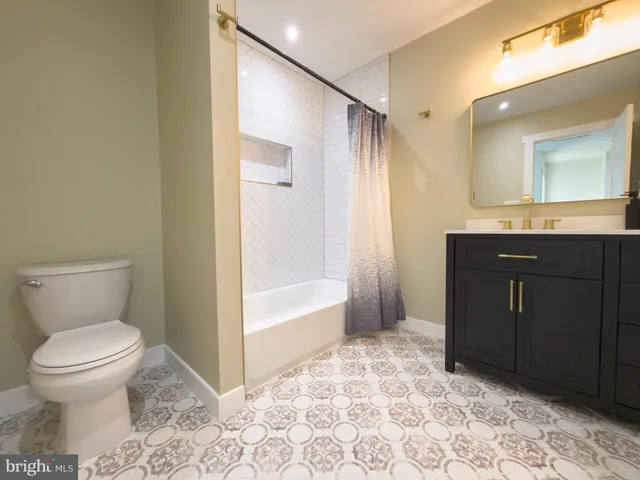 a room with a dresser and mirror