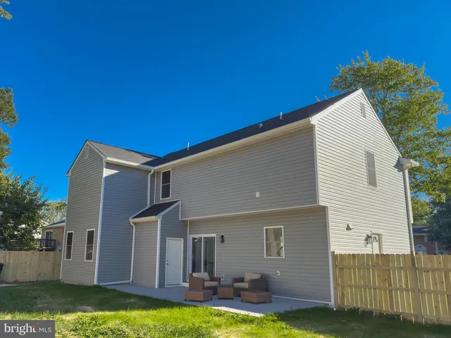 a view of a backyard with large trees