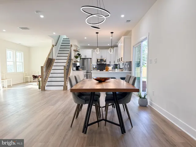 a view of a dining room with furniture wooden floor and chandelier