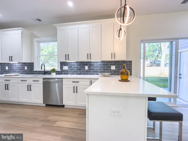 a kitchen with a sink cabinets and window