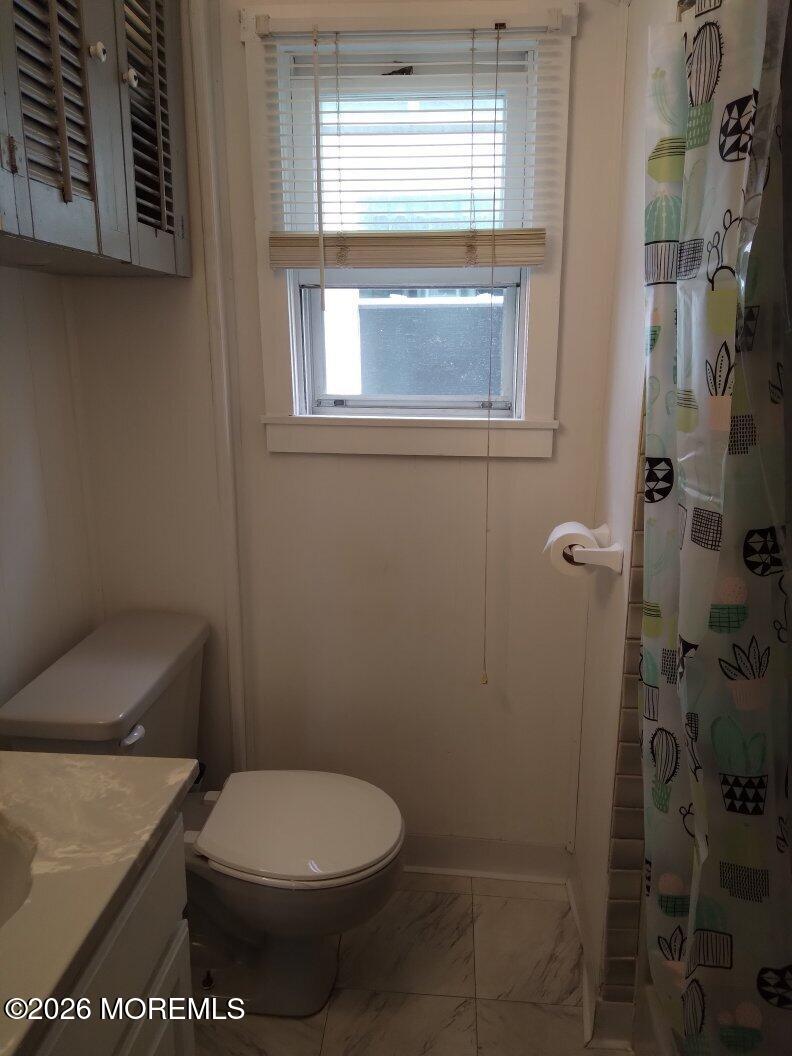 10 Lake Street Point Pleasant Beach, NJ 08742 - Photo 11 of 20 a white toilet sitting next to a window in a bathroom