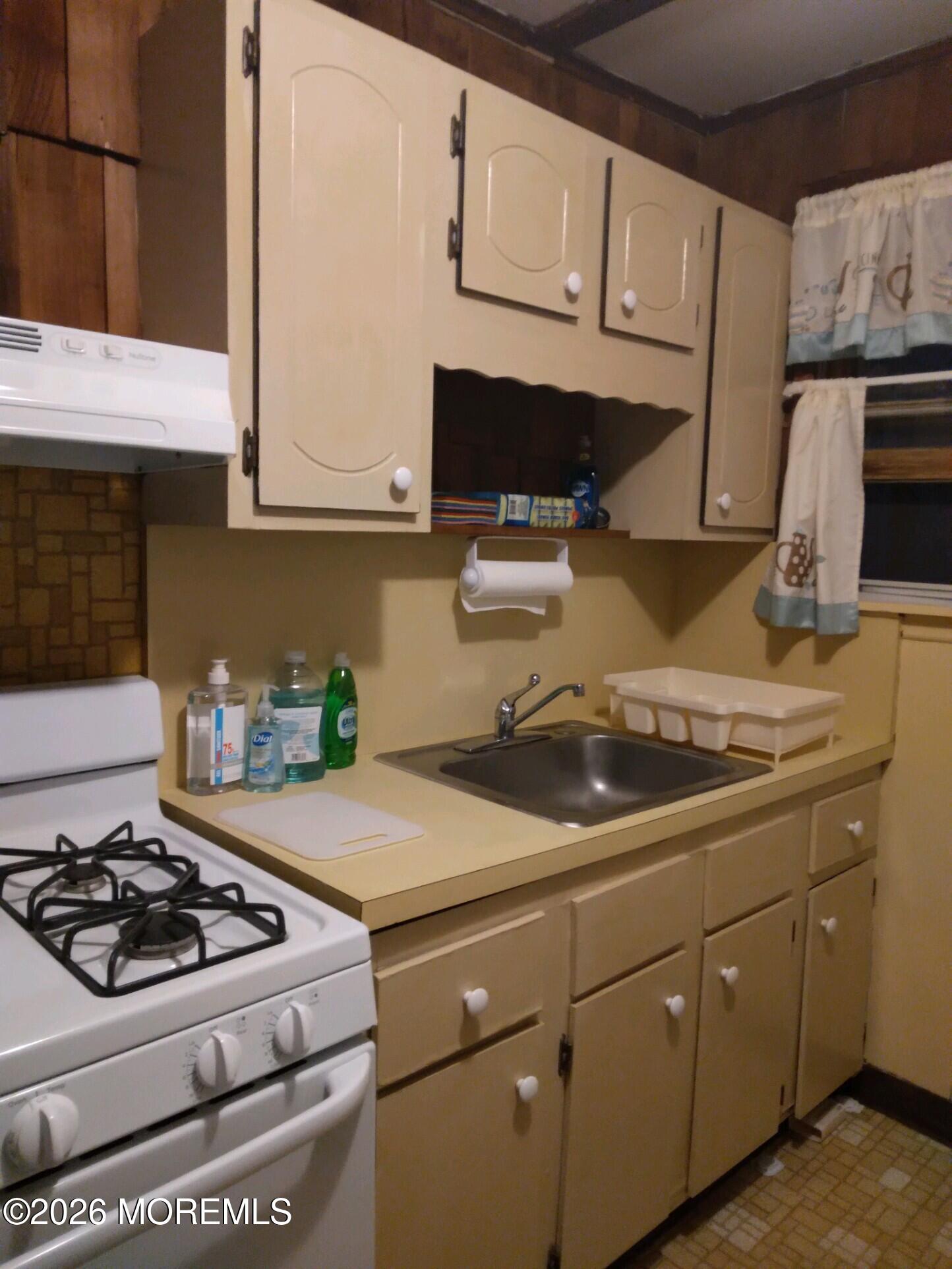 10 Lake Street Point Pleasant Beach, NJ 08742 - Photo 17 of 20 a kitchen with a sink stove and cabinets