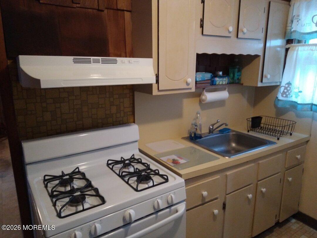 10 Lake Street Point Pleasant Beach, NJ 08742 - Photo 7 of 20 a kitchen with a stove and a sink